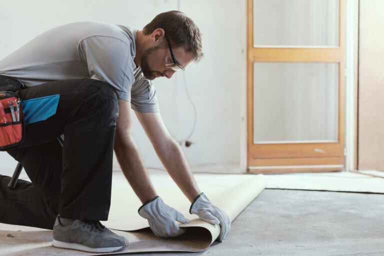 professional contractor removing old linoleum flooring home renovation concept